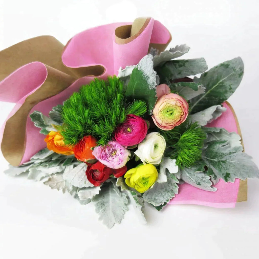 Bubblegum Hues™ Bouquet - Bright Ranunculus becomes even more vibrant with green dianthus and dusty miller