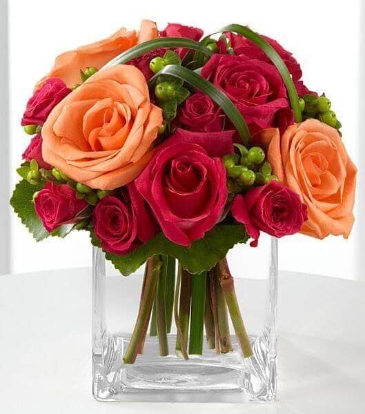 Deep Emotions® Rose Bouquet -fuchsia roses , fuchsia spray roses , orange roses , green hypericum berries , lily grass , vase arrangement
