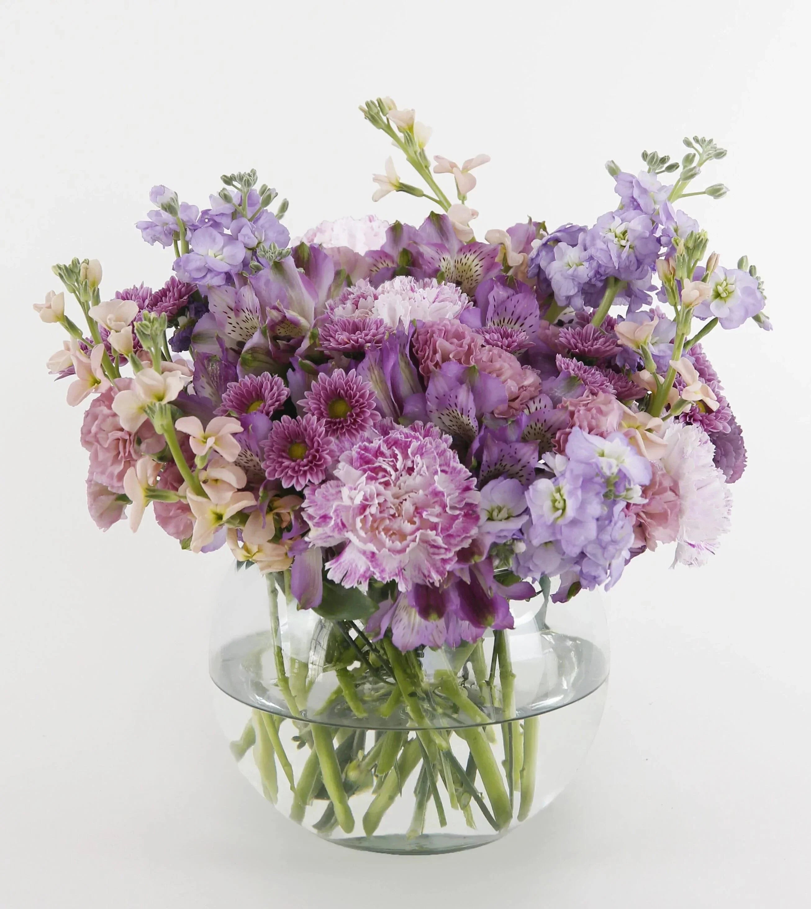 Delightful Discoveries Bouquet Fuller- lavender stock flowers, cream stock flowers, pink novelty carnations, purple alstroemeria flowers, purple button mums