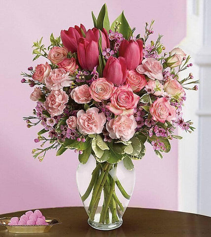 Full Of Love Bouquet - vase with pink roses, tulips, carnations and waxflower, accented with fresh pitta negra and variegated pittosporum