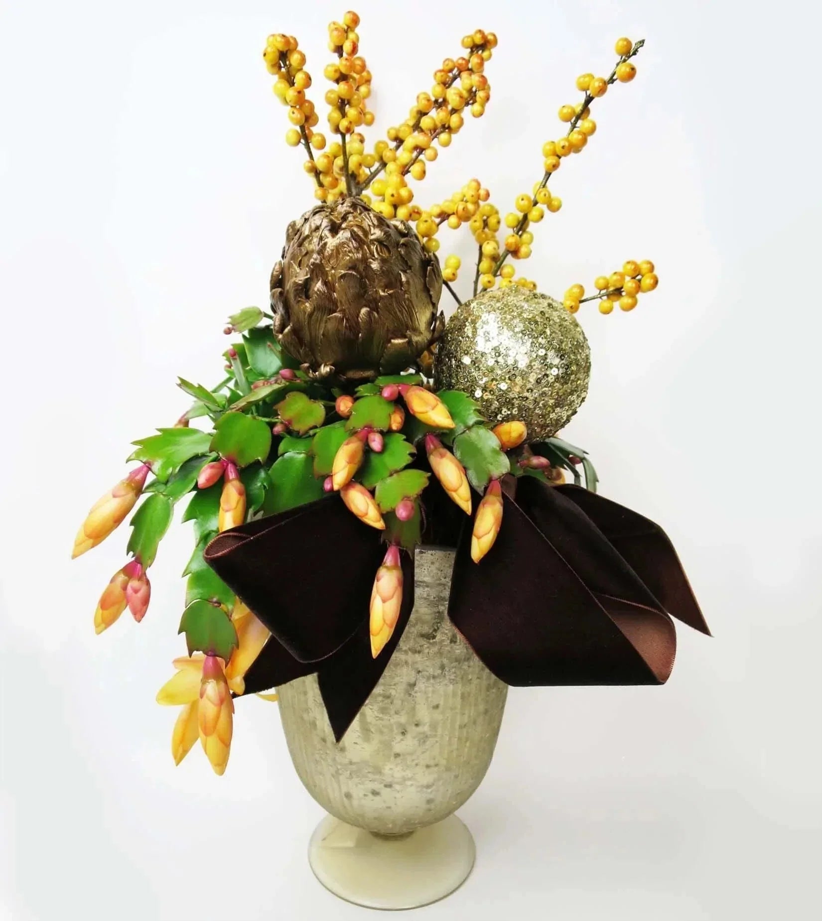 Pot of Gold Christmas Cactus™ - vase with orange Ilex berries and Christmas Cactus are accented with gold painted Artichoke and a festive ornament.