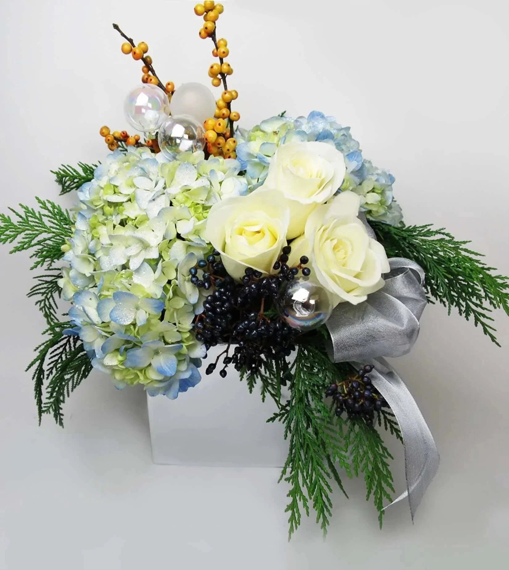 Seventh Night™ Bouquet - vase with blue hydrangeas and white roses is complemented by gorgeous orange ilex and black viburnum berries
